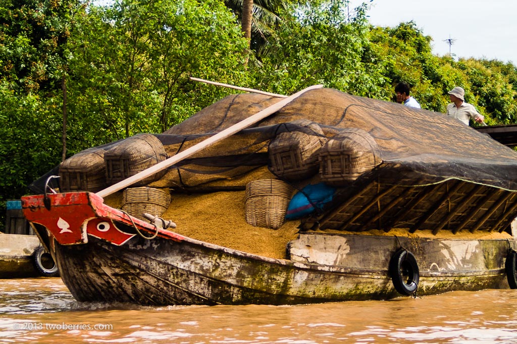 Boat carrying rice husk, Mekong Delta